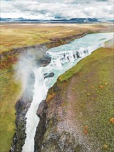 Huge beautiful waterfall Gullfoss, famous landmark in Iceland. River foaming whilst falling down