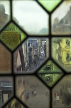 Rouen, France, August 30, 2018: View of the city street through the old window on the clock tower