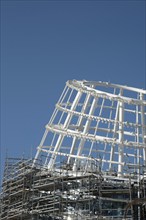 Modern Residential office building construction site and cranes during a vibrant summer day with