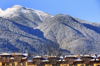 Houses and snow Pirin mountains landscape panorama in bulgarian ski resort Bansko, Bulgaria, Europe