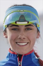 Portrait of smiling sportswoman biathlete Polina Yegorova Kazakhstan at finish after rifle shooting