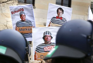 Posters show Chancellor Merkel, virologist Christian Drosten and SPD MP Lauterbach in prisoner's