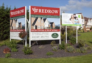 Redrow advertising poster signs for new housing for sale at Cherhill View, Stockley Grange, near