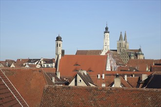 Townscape with spire of St. Johannis church, white town hall tower, half-timbered house