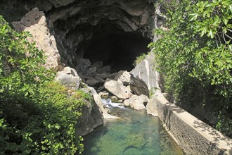 Person exploring entrance ot cave, Cueva del Gato, Benaojan, Serrania de Ronda, Malaga province,