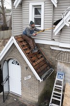 Detroit, Michigan, Workers replace a roof on a vacant house in the Morningside neighborhood. They