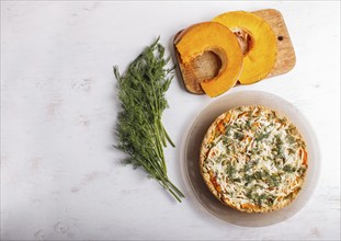 Sweet pumpkin pie with cheese and dill on white wooden background. top view. copy space