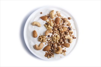 White plate with greek yogurt granola, almond, cashew, walnuts isolated on white background. top