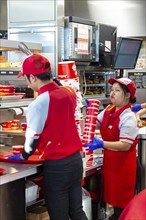 Sterling Heights, Michigan, Workers serve up Chickenjoy fried chicken at Jollibee, a Filipino fast