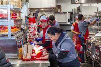 Sterling Heights, Michigan, Workers serve up Chickenjoy fried chicken at Jollibee, a Filipino fast