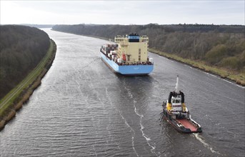 Container ship Laura Maersk is escorted by a tugboat in the Kiel Canal, Schleswig-Holstein,