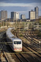 Train on the tracks west of Essen central station, skyline of the city centre, ICE train, North