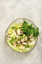 Waldorf salad, celery salad with apple, in a glass salad bowl, natural light, homemade, no people