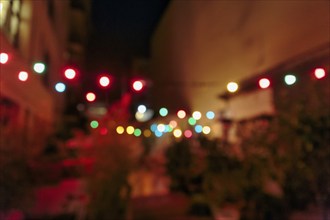 Bokeh balls, colourful string of lights on roof terrace, night shot, Gracia, Barcelona, Spain,