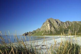 Island in the sea with calm sandy beach and blue sky with clouds, Bleik, Vesteralen, Langoya,