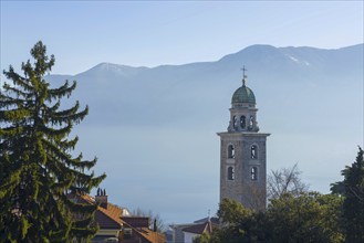 Church Tower and Trees in Mountain Valley in a Misty Sunny Day in City of Lugano, Ticino,