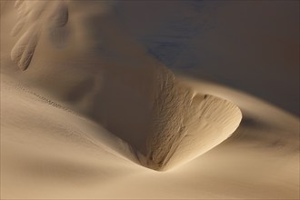 Gentle sand dunes under a clear blue sky with playful shadows, Matruh, Great Sand Sea, Libyan