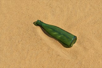 Green bottle lying in the sand in the desert, Matruh, Great Sand Sea, Libyan Desert, Sahara, Egypt,