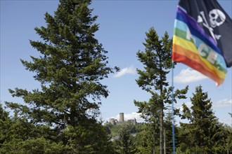 Adenau, Germany, 8 June 2024: The Nürburg can be seen in the background while a rainbow flag and a