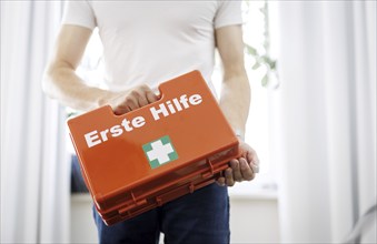 Occupational safety. A man holds a first aid kit in an office in Berlin, 09/08/2024