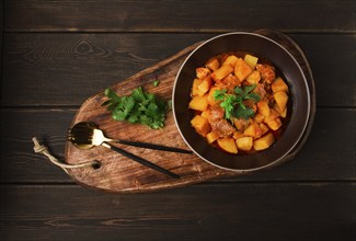 Potatoes stewed with meat, in tomato sauce, with spices and herbs, no people