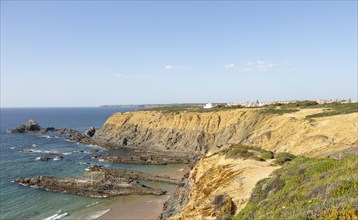 Rocky coastal landscape Praia dos Alteirinhos beach in bay with rocky headland part of Parque