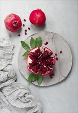 Fresh, cut pomegranate fruit, on a gray background, food concept, top view, no people