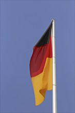 German flag in front of a blue sky