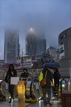 Rainy weather, freezing rain, entrance to Hauptwache underground station, high-rise skyline in