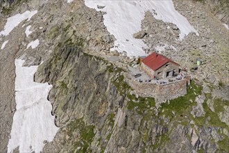 Aerial view of mountain hut Cabane de l'A Neuve, located on a steep rock formation, near La Fouly,