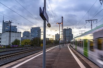 Regional train arriving at Essen central station, platform, city centre skyline, North