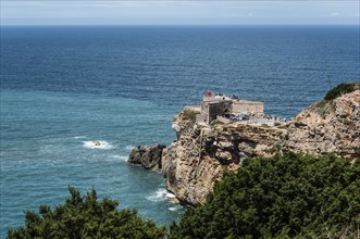 Lighthouse on the coast, on cliffs, surrounded by sea and forest, blue sky in the background, Fort