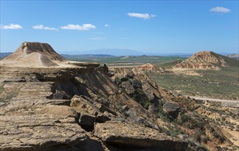 Vast landscape with a plateau and hills under a clear blue sky, Bardenas Reales Natural Park,