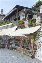 A souvenir shop with a variety of artefacts on a traditional wall, Makrinitsa, Balcony of Pelion,