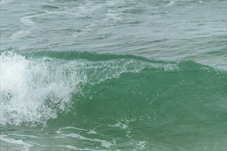 Turquoise blue wave in the Iroise Sea. Camaret, Crozon, Brittany, France, Europe