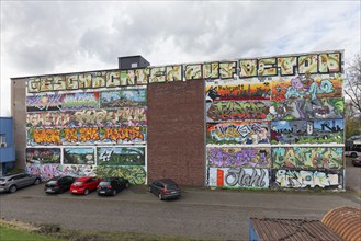 Industrial building completely painted with graffiti, various pictures on the themes of Ruhrpott