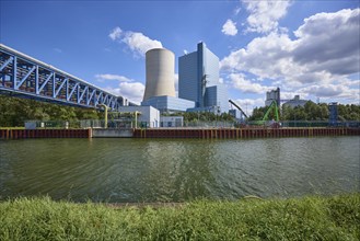 Coal-fired power plant Datteln 4 at the Dortmund-Ems canal under a blue sky with cumulus clouds in