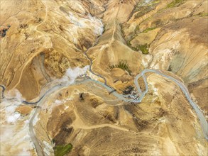 Steaming hot springs and colourful rhyolite mountains, aerial view, Hveradalir geothermal area,