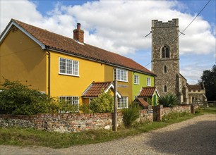 Historic cottages next to village parish church of All Saints, Rede, Suffolk, England, UK