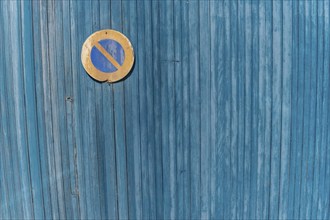 Garage door boards stained blue with worn paint. Brittany France