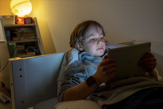 A boy plays computer games on a tablet PC