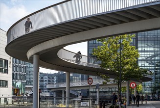 Cyclists on the Cykelslangen cycle and pedestrian bridge, at the Fisketorvet shopping centre,