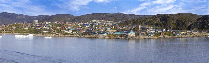 Typical architecture of Greenland Ilulissat with colored houses located near fjords and icebergs