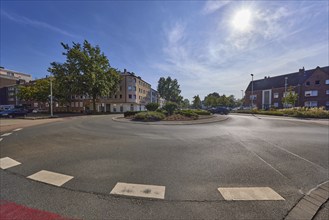 Roundabout at the intersection of Bismarckstraße, Augustastraße and Moltkestraße backlit by the sun