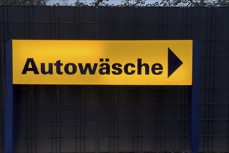 Illuminated sign with inscription car wash and directional arrow, Germany, Europe