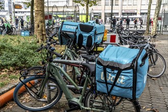 Wolt delivery service, parked bikes of bicycle couriers with thermal backpack, in front of the main