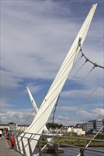 Detail of a modern bridge under a slightly cloudy sky, Londonderry