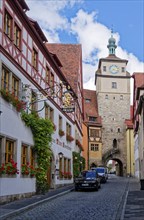 Historic half-timbered house, Hotel Tilman Riemenschneider, with blooming flower boxes in front of