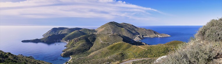 Panoramic view of a group of islands with green hills and blue sea under a cloudless sky, southern