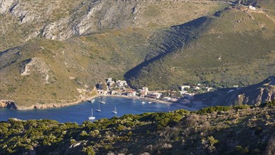 Small settlement on a bay with sailing boats and surrounded by mountains, southern tip, Mani